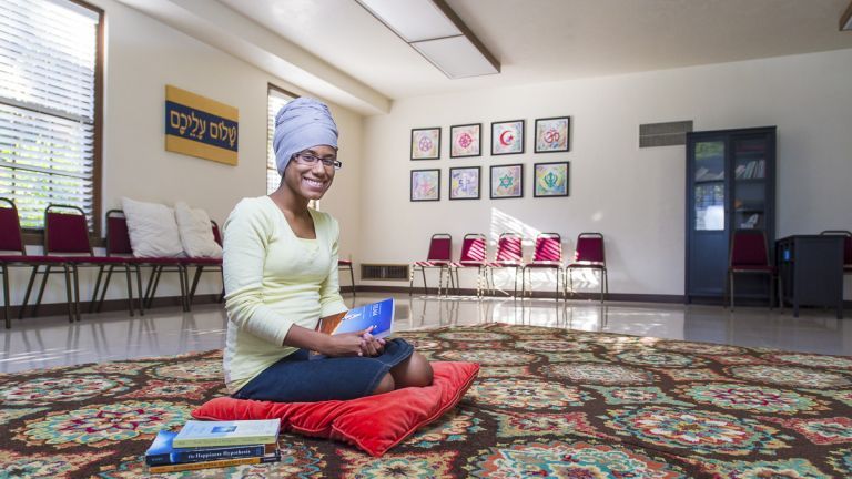 Student kneeling in sacred space