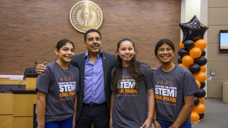 Jose Hernandez standing with students