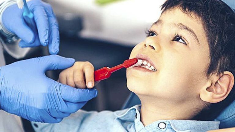 boy with red toothbrush