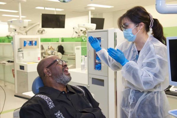 Smiling man in clinic talking to dentist