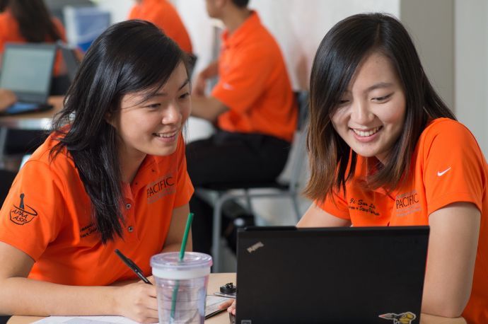 Two PharmD students with laptops