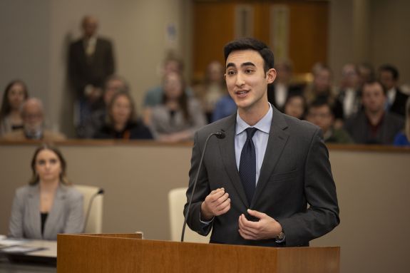 An action shot of a student in a courtroom