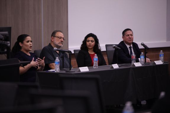 panel speakers speaking to a crowd of listeners