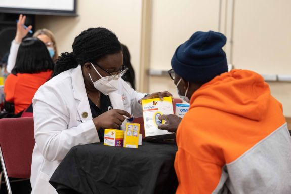 Student with patient at diabetes clinic