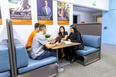 students conversing around a table