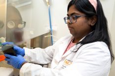 Student wearing lab coat in research lab