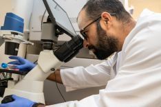 Student wearing lab coat in research lab