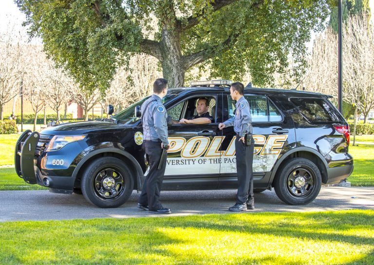 public safety employees around vehicle