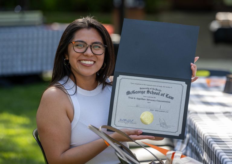 student holding a certificate