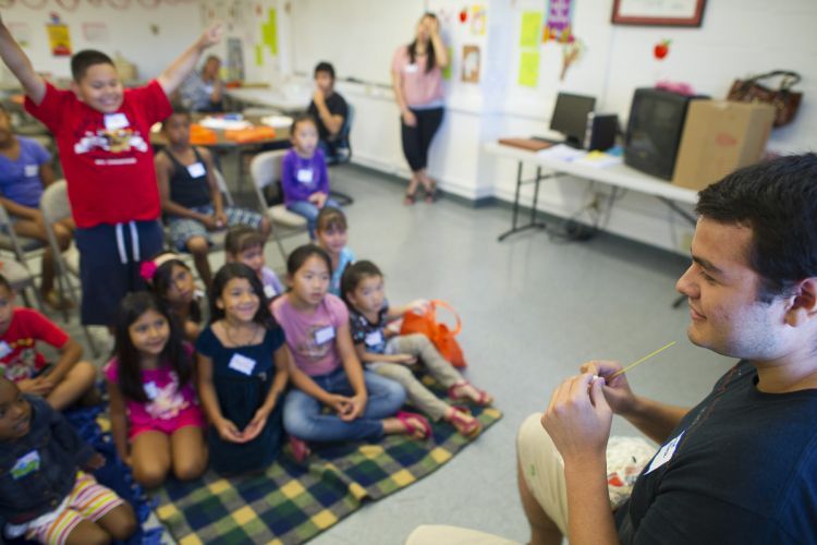 Student reading to kids