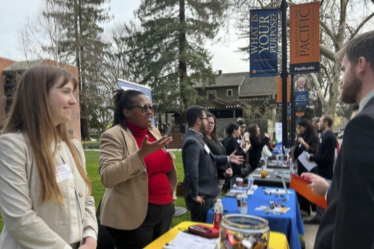 A handful of employers talk to students at a career fair