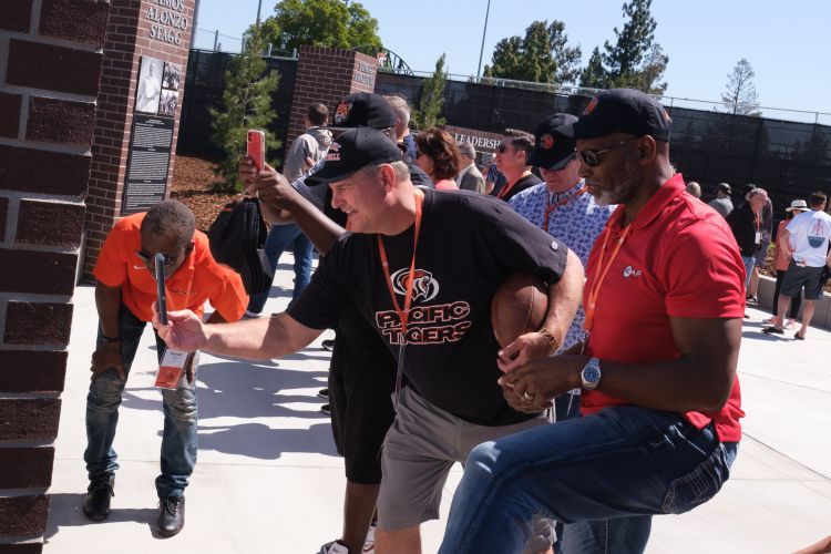 former football players looking at new football plaza