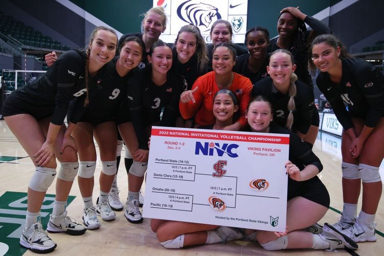 volleyball players stand on the court holding a bracket