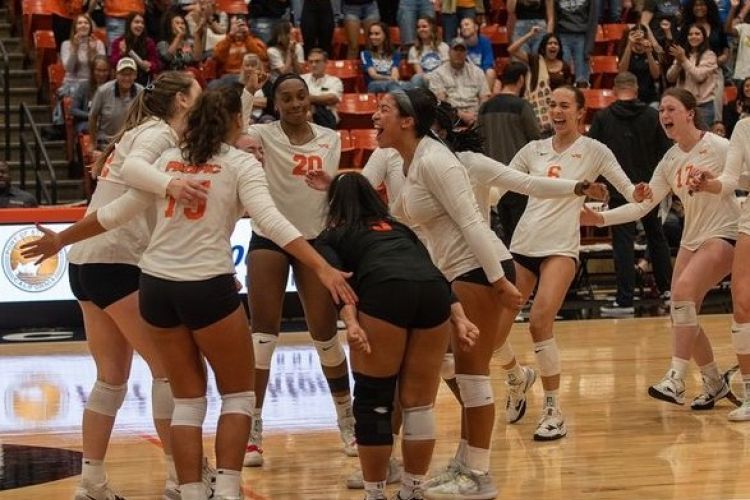 women's volleyball team celebrates on the court