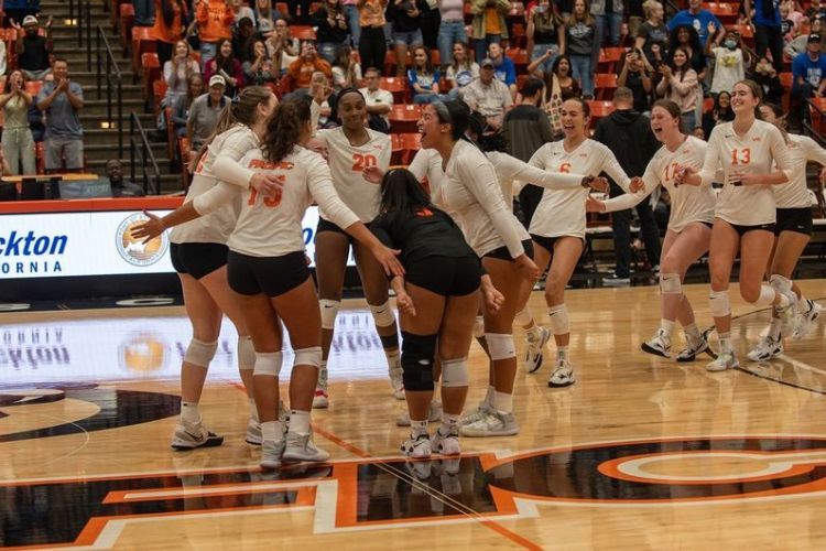 women's volleyball team celebrates on the court