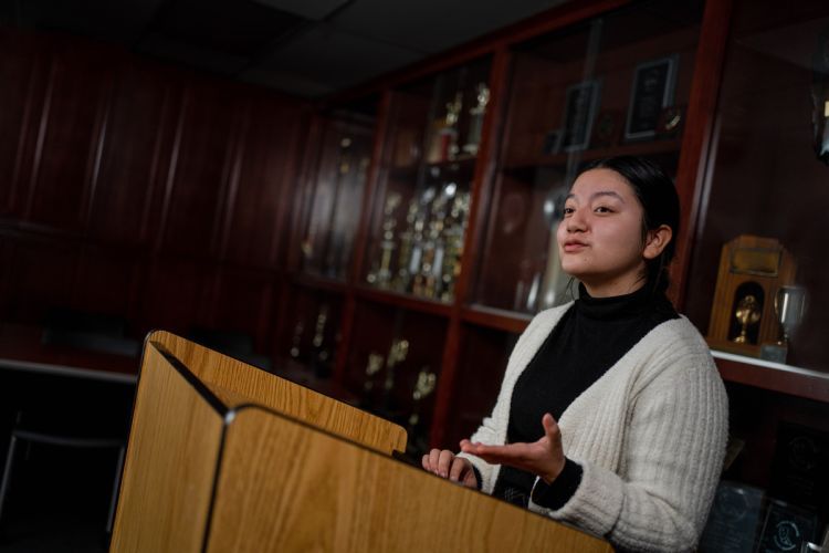 a student gives a speech at a podium