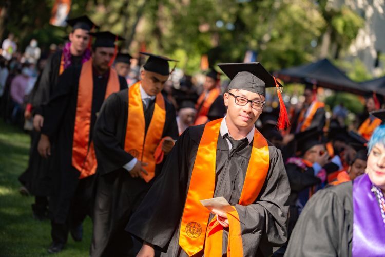 students in caps and gowns at a graduation ceremony