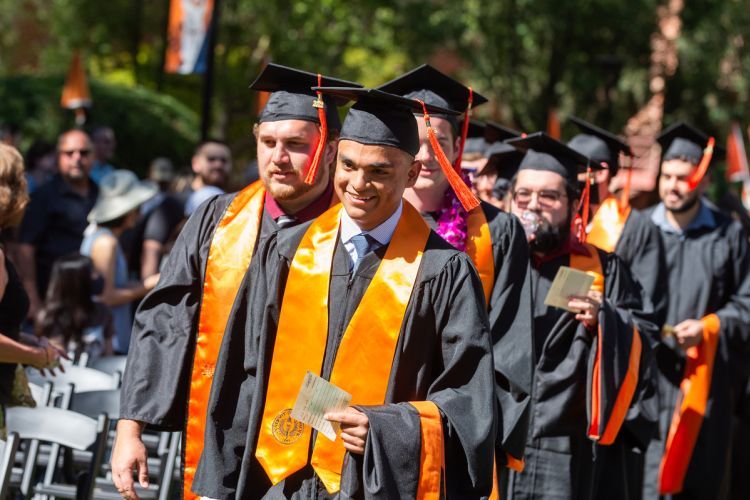 students walk at commencement ceremony