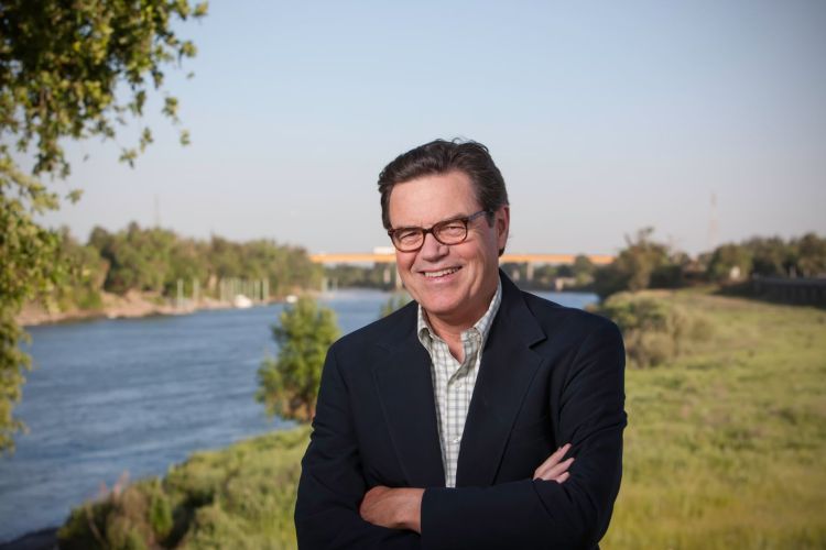 Stephen McCaffrey stands next to a river