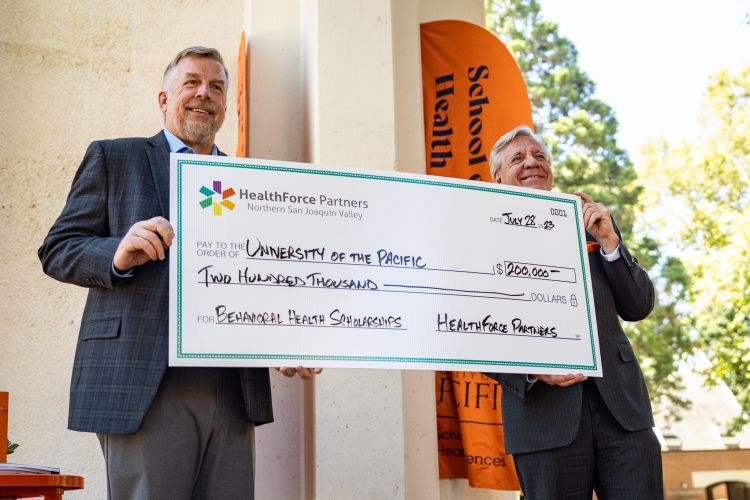 Paul Lanning presents a check to President Christopher Callahan