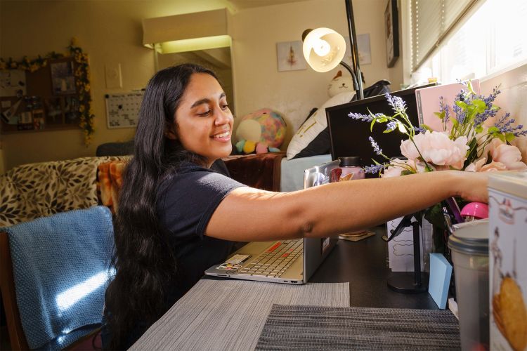 a student sits in a dorm room