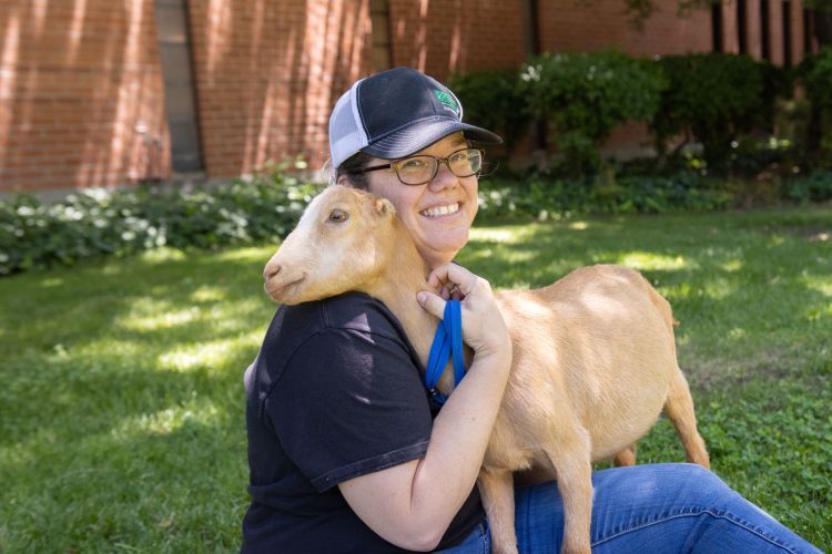 Melanie Felmlee hugging a goat.