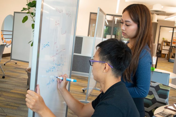 a student works with a peer tutor in the tutoring center