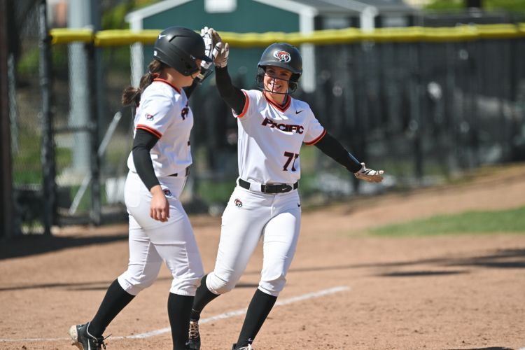 softball players give each other a high five