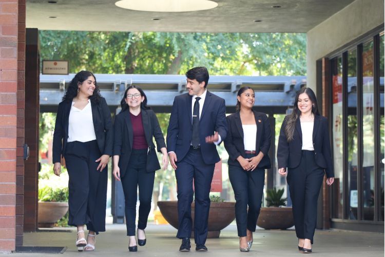 (From left to right) McGeorge students Perla Ornelas-Perez, Devynn Azevedo, Saul Vargas, Natalia Osorio-Elizondo, and Erica Alvarez Ramos walk by the campus breezeway on the Sacramento Campus. The students are members of the Latinx Law Students Association.