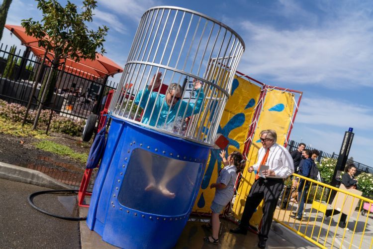 Gale with President Christopher Callahan at the "dunk the dean" tank during Admitted Student Day in 2022. 