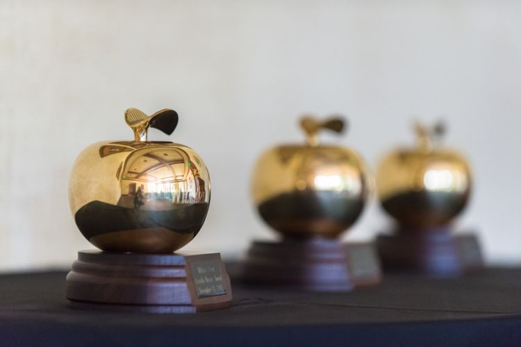 Three golden apple trophies