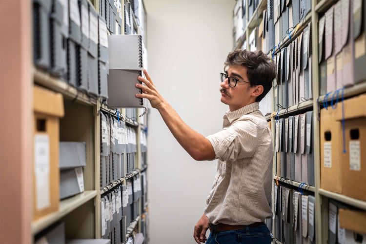 A student looks through material in the Pacific archives.