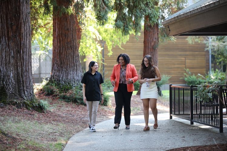 Three women walk across campus at McGeorge School of Law. 