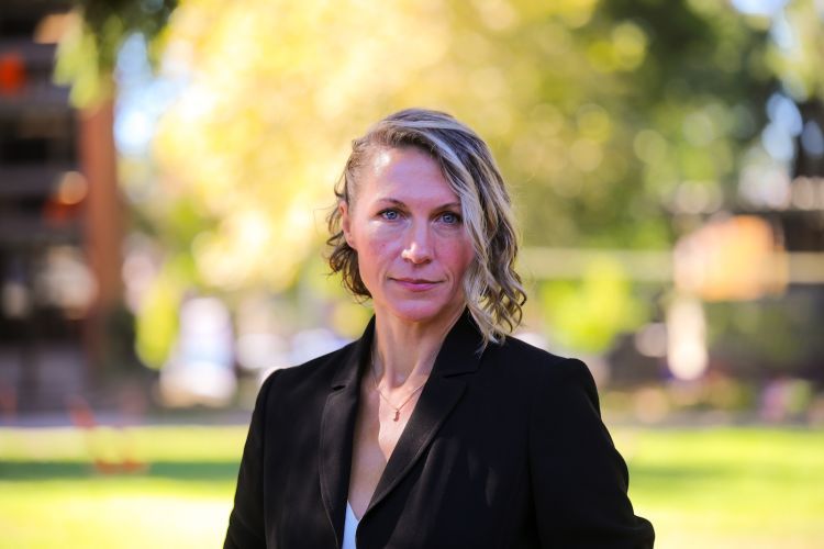 Woman in black blazer talks a headshot