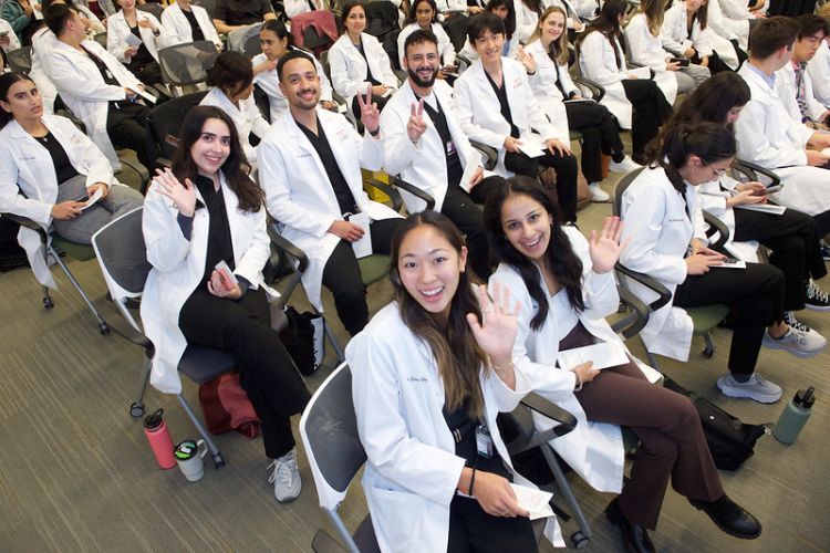 group of student-researchers in white coats