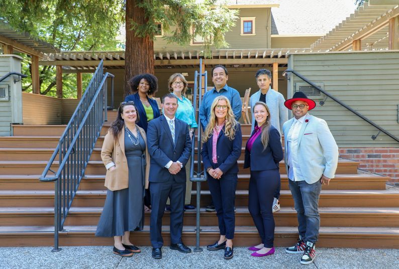 A group of McGeorge faculty pose for a photo outside.