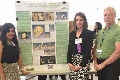 Students Robin Lambert and Riddhima Suri, members of the DDS Class of 2017, along with their faculty advisor Dr. Gary D. Richards, pose with the poster for their project, "A New Insertion Landmark and Modification of the 'Standard Technique' for Inferior Alveolar Nerve Block Injections".