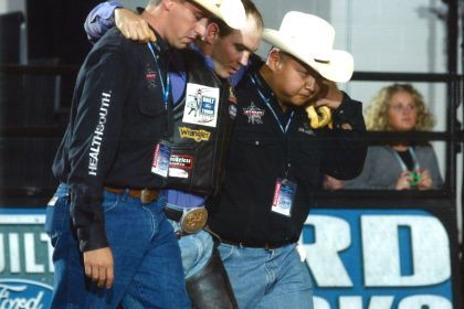 Peter Wang (far right) helps an athlete at a Professional Bull Riders event. 