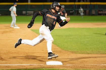 A baseball player runs the bases at a Pacific Tigers game.