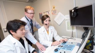 audiology professor and students in lab