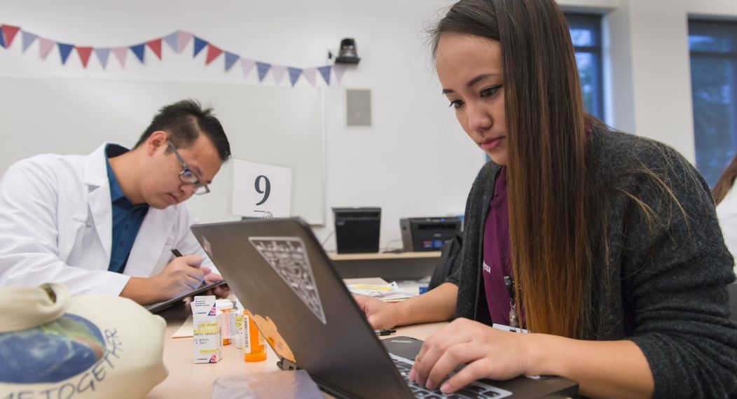 student in front of a laptop