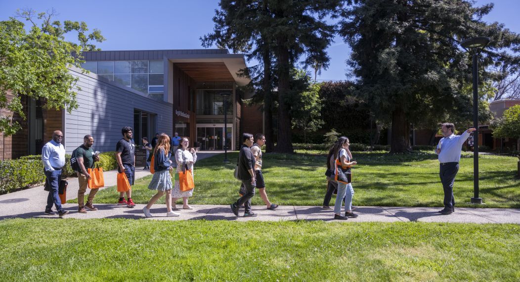 A group of students walk across campus