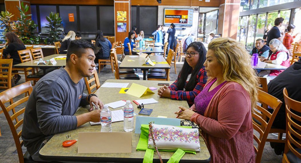 Students working the annual immigration fair.