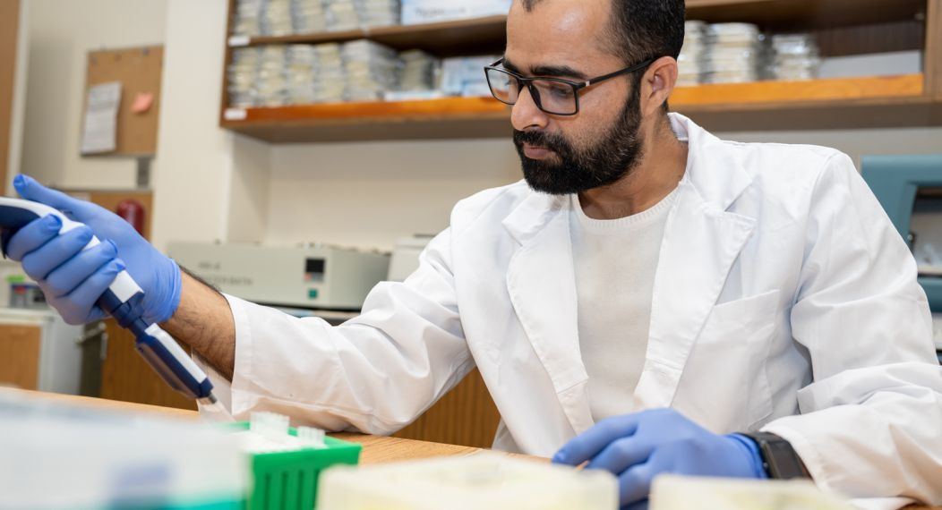 Graduate student conducting research in lab