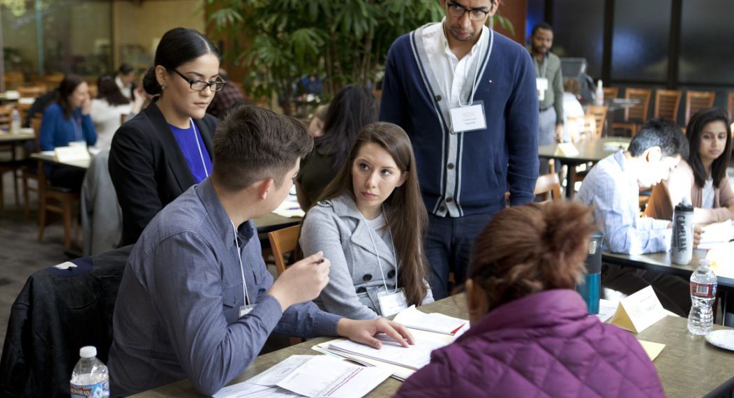 students helping at the mcgeorge immigration fair