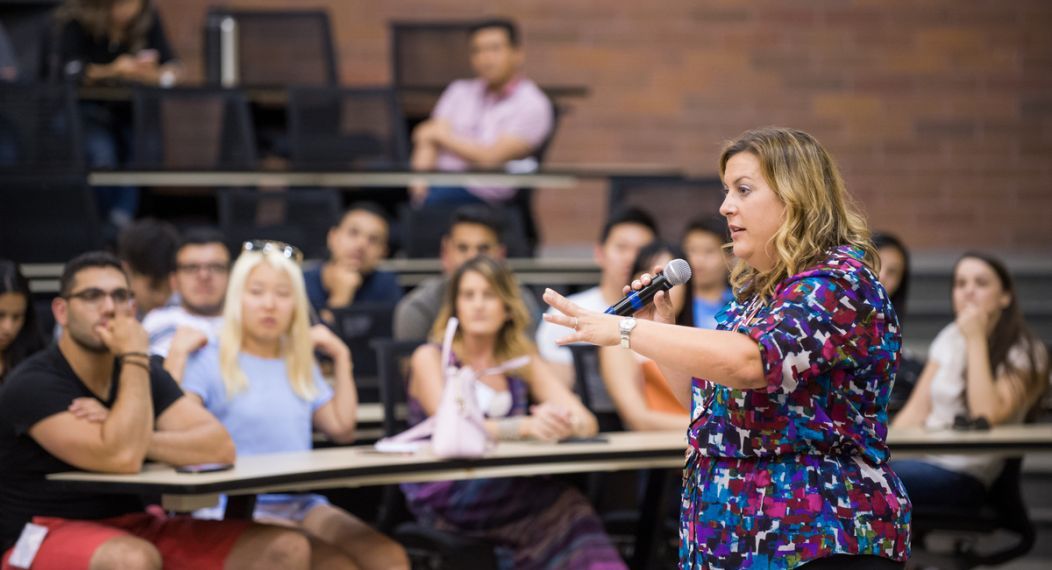 Photo shows PA Department Chair Dr. Tracey DelNero speaking in front of a class. 