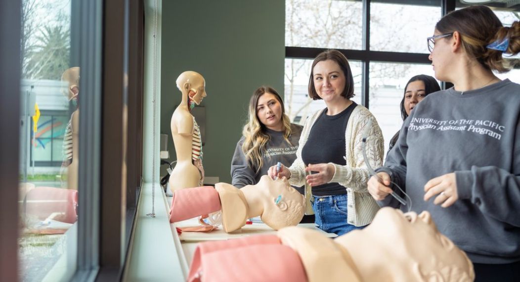 Image shows students practicing a procedure. 