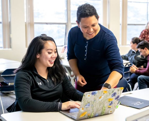 student and professor interacting in classroom