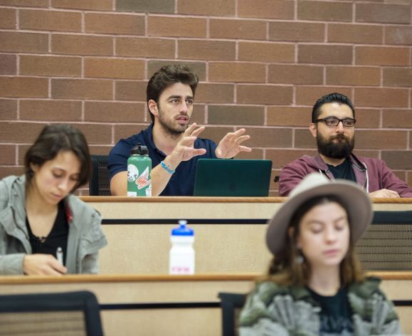 a student talking with a professor during a lecture