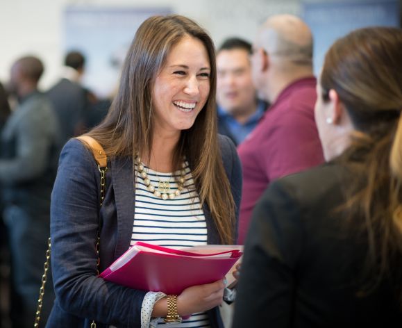 PharmD studnets talks to exhibitor at event in the DeRosa University Center